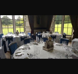 Blue Satin Sashes on White Chair Covers in the dining room at Swinton Park
