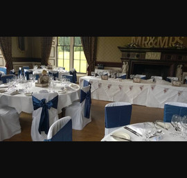 Blue Satin Sashes on White Chair Covers in the dining room at Swinton Park