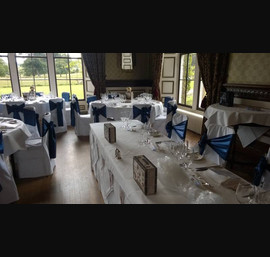 Blue Satin Sashes on White Chair Covers in the dining room at Swinton Park
