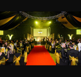 Yellow Organza sashes on venues own chair covers at the White Rose Awards, New Dock, Leeds