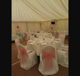 Coral organza sashes on white chair covers at Wetherby Racecourse, on Ladies Day