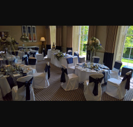 Blue Satin sashes on white chair covers at Rudding Park