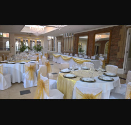 Gold Organza sashes on white chair covers at Goldsborough Hall