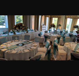 Teal Organza sashes on white chair covers at Rudding Park