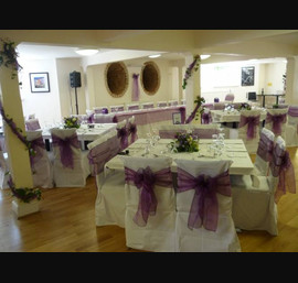 White linen chair cover with purple organza bow
