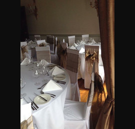 Bronze Sashes on White Chair Covers at Fasque House