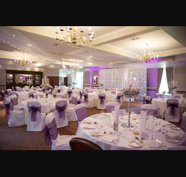 Purple Sashes on White Chair Covers at Norwood Hall (photo courtesy of Janie Barclay)