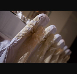 Gold Flock Sashes on White Chair Covers at Double Tree by Hilton Hotel (photos by Janie Barclay)
