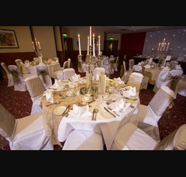 Bronze Sashes on White Chair Covers at Double Tree by Hilton Hotel (photos by Janie Barclay)