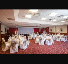 Bronze Sashes on White Chair Covers at Double Tree by Hilton Hotel (photos by Janie Barclay)