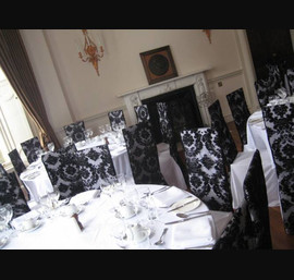 Black Flock Hood on White Chair Covers at Fasque House