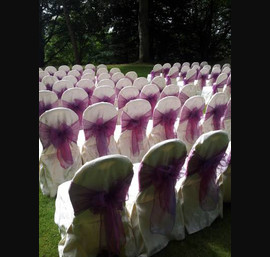 Pink/purple organza sash on hotel's own chair covers at Norwood Hall