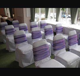 Purple Sashes on White Chair Covers at the Old Mill Inn