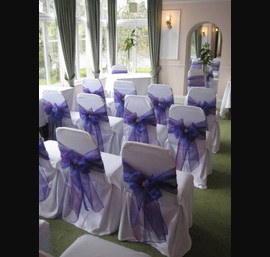 Purple Sashes on White Chair Covers at the Old Mill Inn