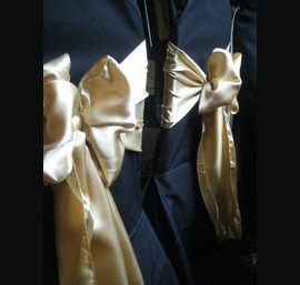 Gold Satin Sashes on Black Chair Covers at Rox Hotel