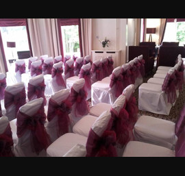 Fuscia and Heather Sashes on White Chair Covers at Tor Na Coille