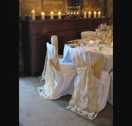 Champagne flock ties on white chair cover