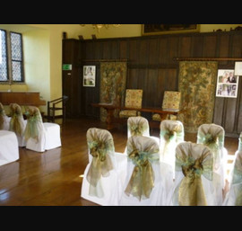 Two tone green and bronze tied in a hood on white chair covers