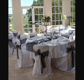Black and white double centre bow on white chair cover