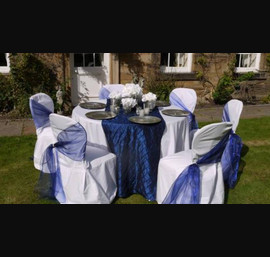 Midnight blue single side sash tied with pearls on white chair cover