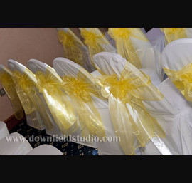 Yellow single sash on white chair cover at Forbes of Kingennie