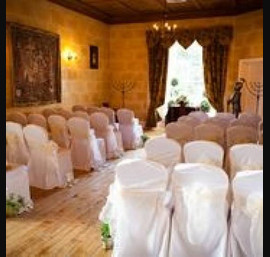 Ivory single bow on white chair cover at Fernie Castle