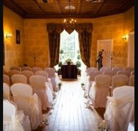 Ivory single sash on white chair cover at Fernie Castle