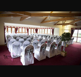 Silver single bow on white chair cover at Forbes of Kingennie, ceremony style
