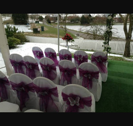 Cadbury purple single bow on white chair cover with butterfly brooch at Forbes of Kingennie
