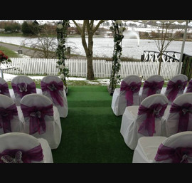 Cadbury purple single bow on white chair cover with butterfly brooch at Forbes of Kingennie