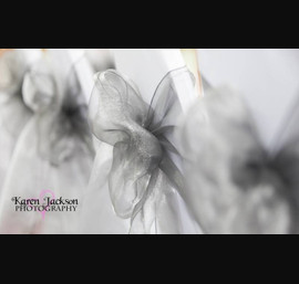 Silver single bow on white chair cover at Forbes of Kingennie