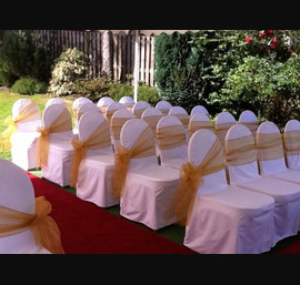 Gold single bow with side aisle bows on white chair covers at Forbes of Kingennie