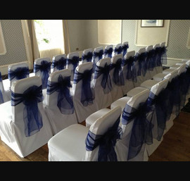Navy single bow on white chair cover at The Queens Hotel