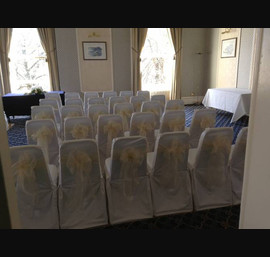 Ivory single bow on white chair cover at The Queens Hotel