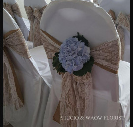 Hessian bow with lace on white chair cover