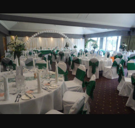 Emerald green satin bows on white chair covers