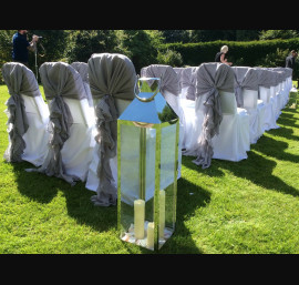 Grey chiffon ruffles on white chair covers