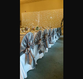 Silver chair hoods on white chair cover