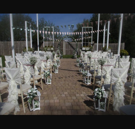 Ivory Ruffle Tail Hoods on Limewash Chiavari Chairs