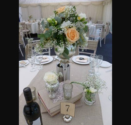 Vintage centrepiece on burlap table runner