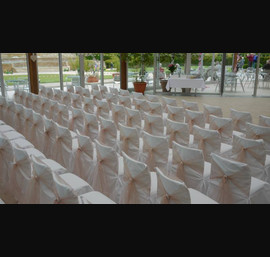 White Chair Covers and antique pink sashes tied in a pony tail with pearl accessories at Alnwick Gardens