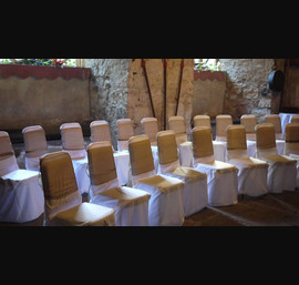 White chair cover, bronze bow at Chillingham Castle