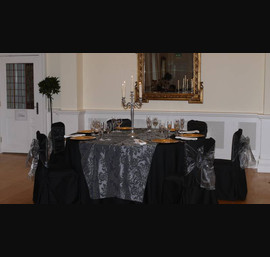 Black linen with grey flock taffeta table runners and matching bows