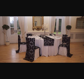 Black flock chair backs on white chair covers
