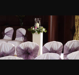White Chair Covers and Heather bows at Doxford Hall. Flowers Katherine's Florist
