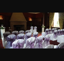 White Chair Covers and Heather bows at Doxford Hall. Flowers by Katherine's Florist