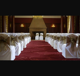 White Chair Covers and Bronze bows at Doxford Hall