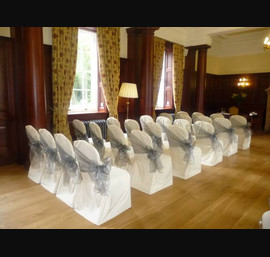 Buttermilk chair covers with silver side bows at Doxford Hall
