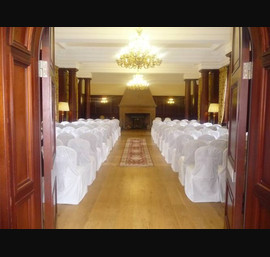 White chair covers and white bows at Doxford Hall