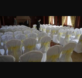 White Chair Covers and yellow skinny bows at Doxford Hall
